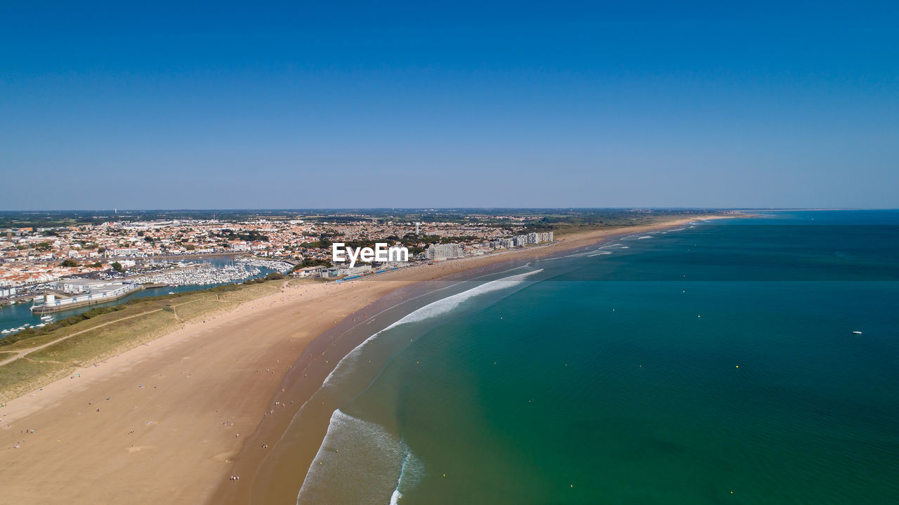 Aerial view of sea against clear blue sky