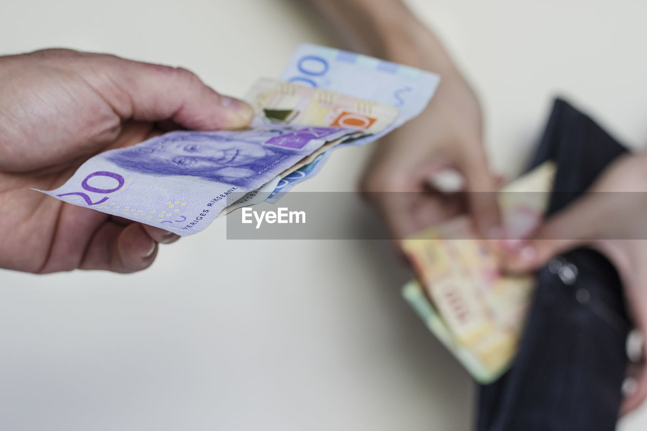 Mexico city.man exchanging swedish krona for mexican pesos.giving and receiving