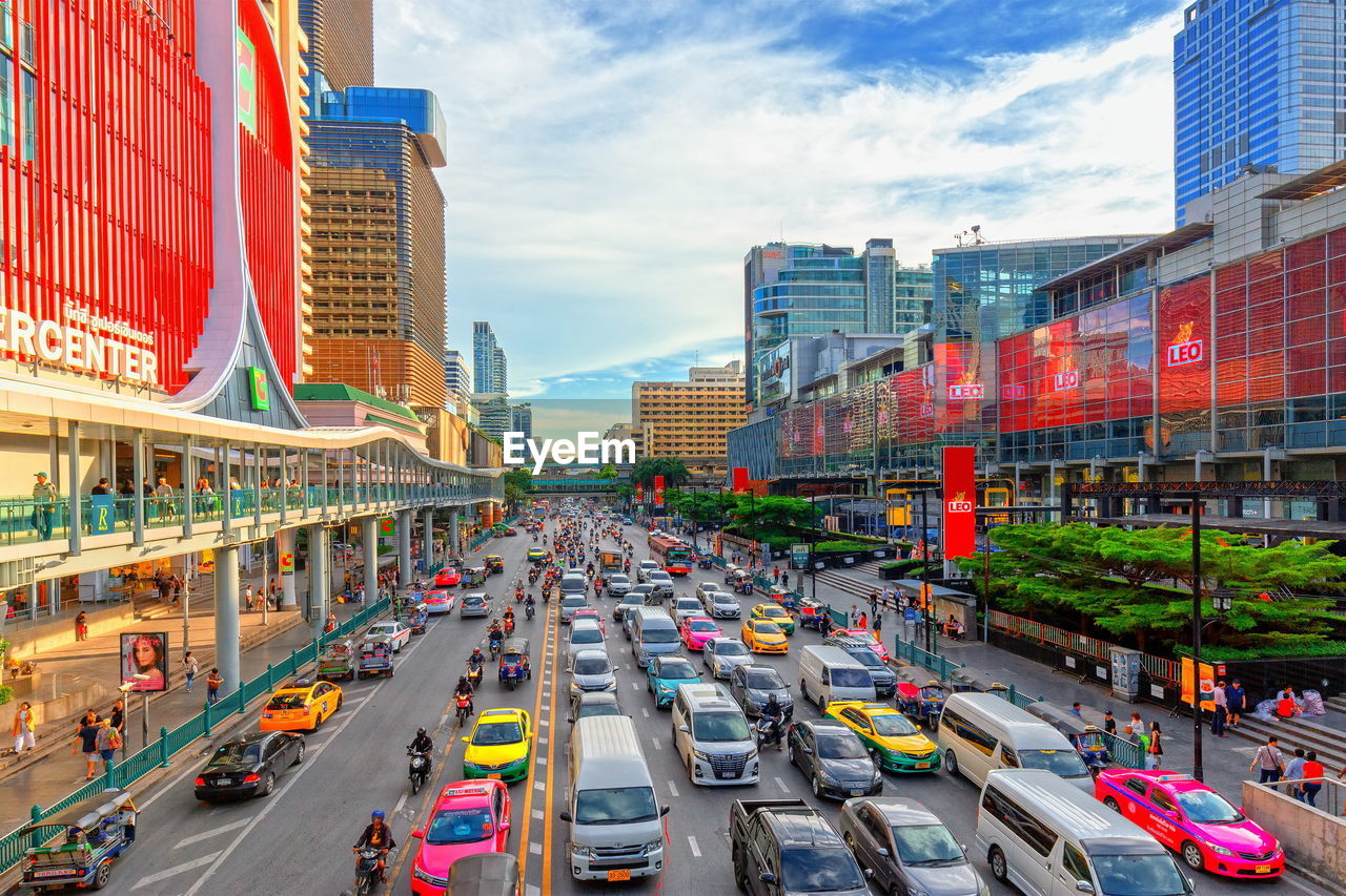 TRAFFIC ON CITY STREET AMIDST BUILDINGS