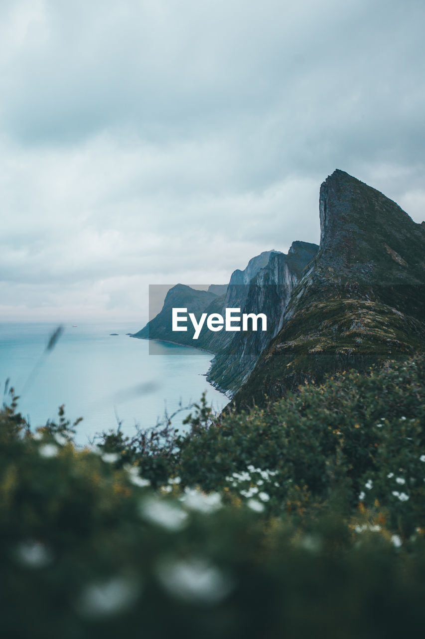 Scenic view of sea and mountains against sky