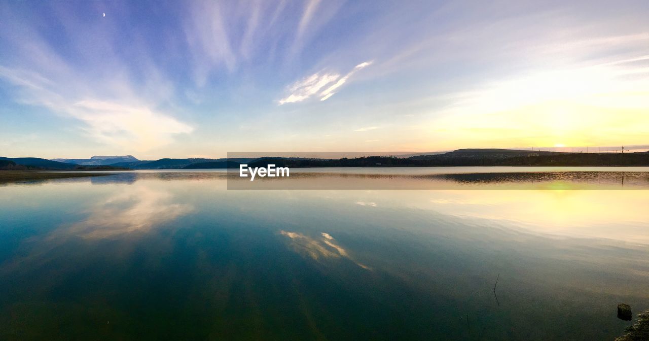 PANORAMIC VIEW OF LAKE AGAINST SKY AT SUNSET