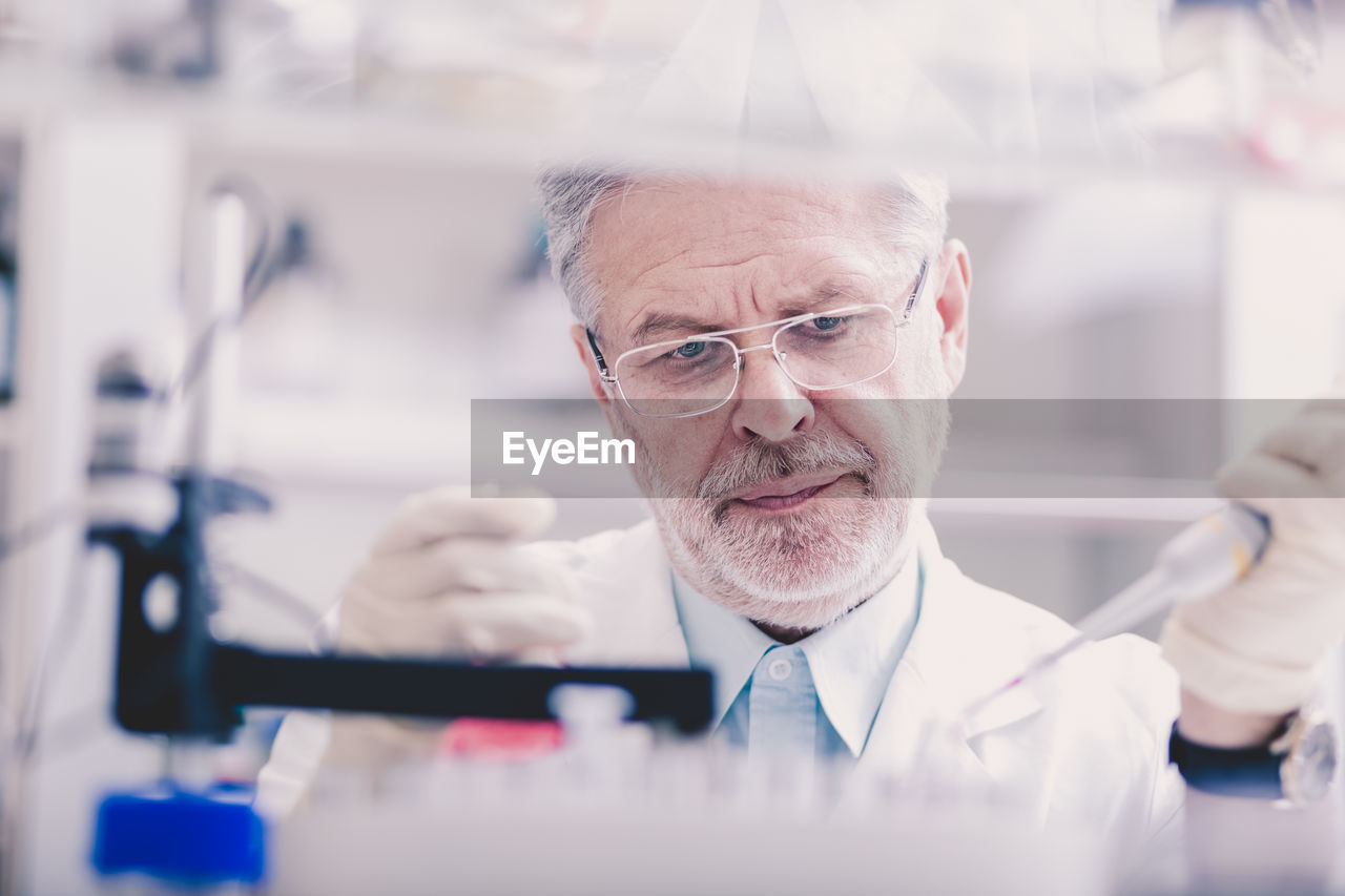 portrait of man using mobile phone in laboratory