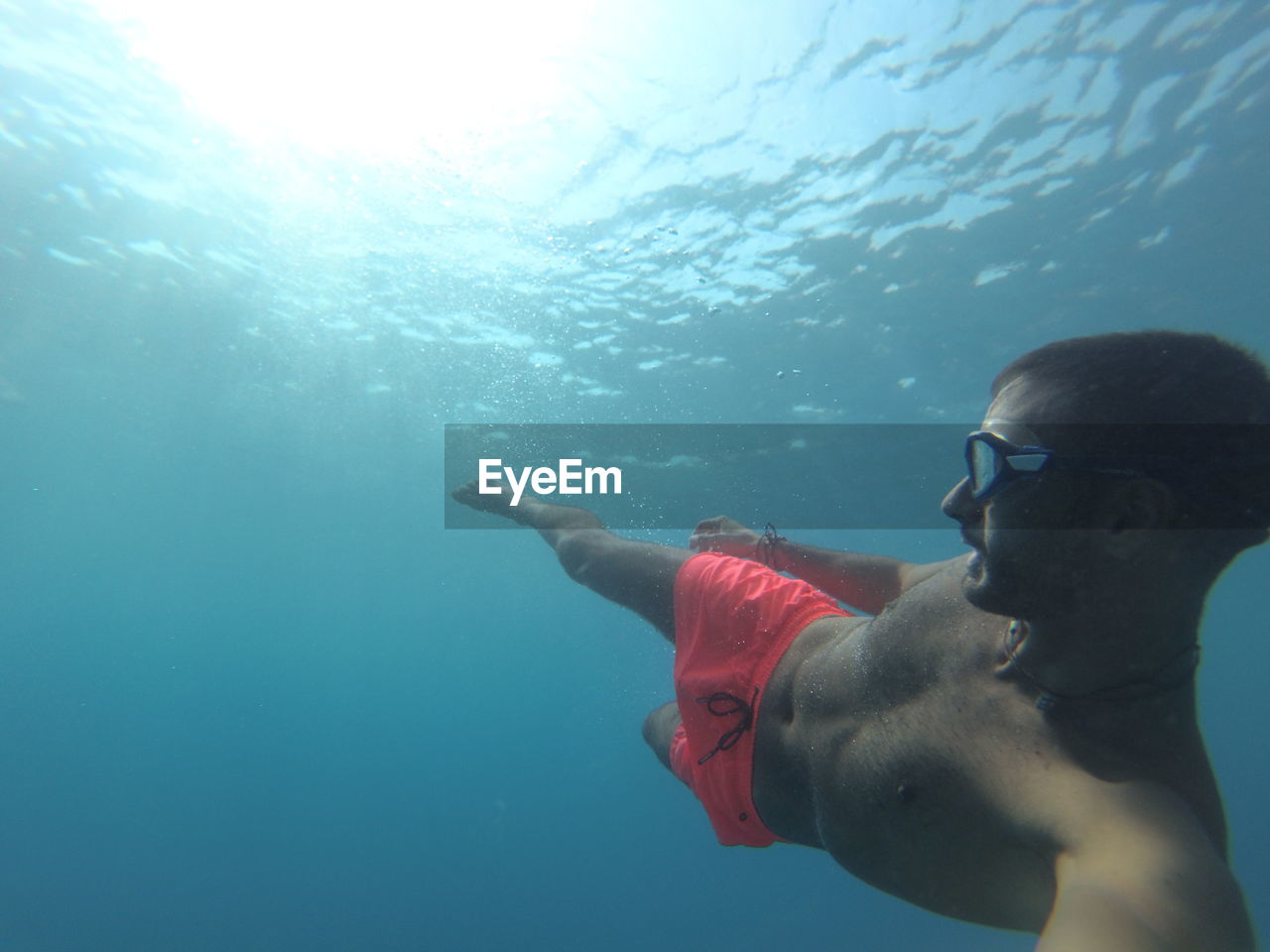 YOUNG MAN SWIMMING IN SEA