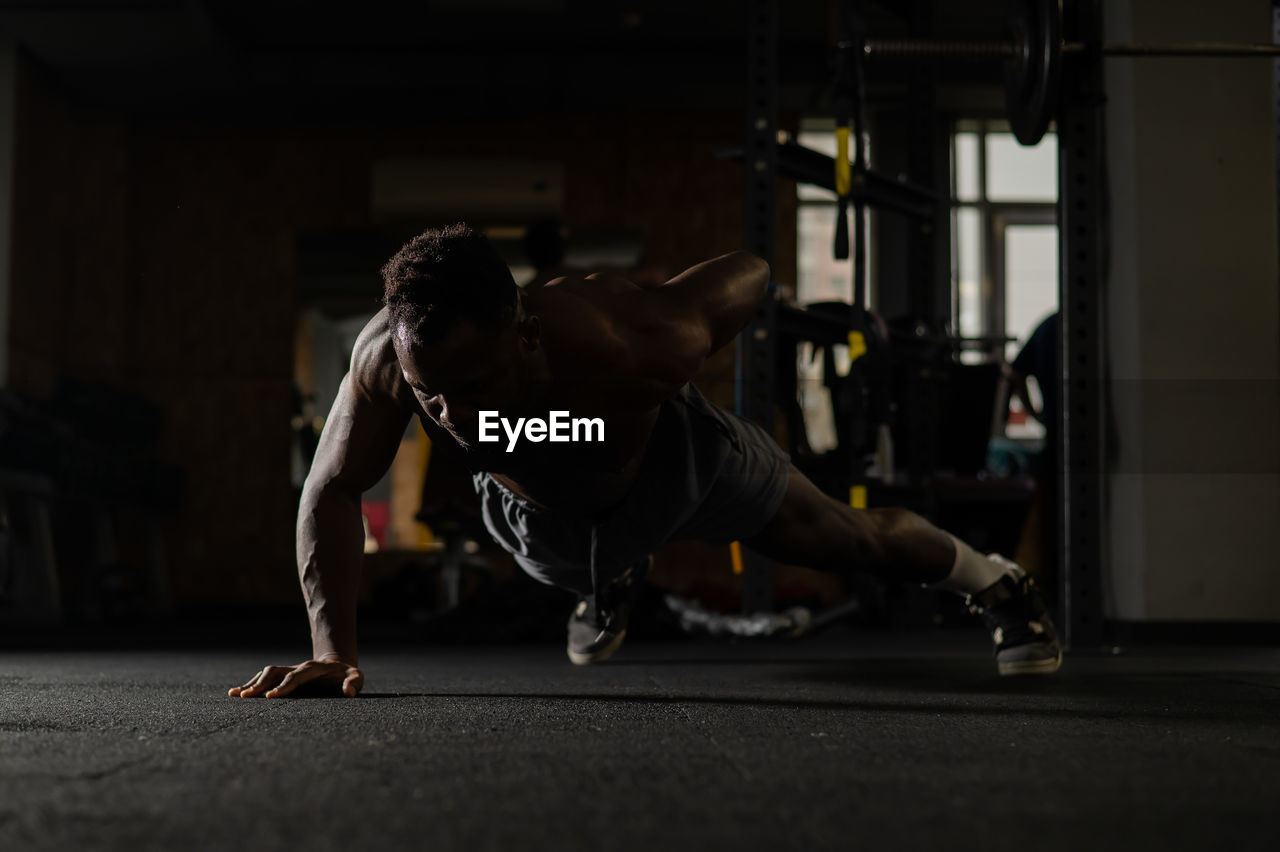 Side view of woman exercising in gym