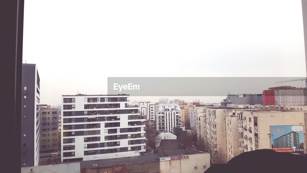 MODERN BUILDINGS AGAINST CLEAR SKY