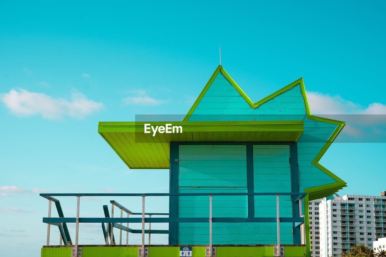 LOW ANGLE VIEW OF YELLOW BUILDING AGAINST SKY