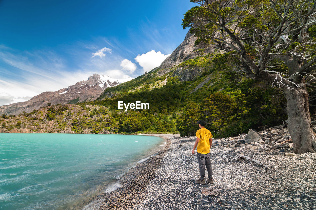 Hiker standing against mountain