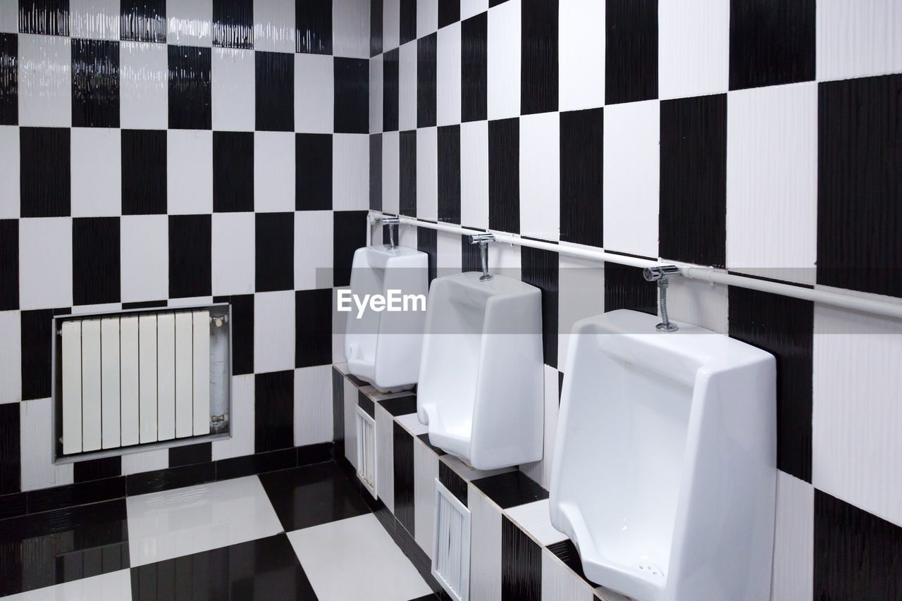 A bright creative toilet, the interior is made of black and white tile.