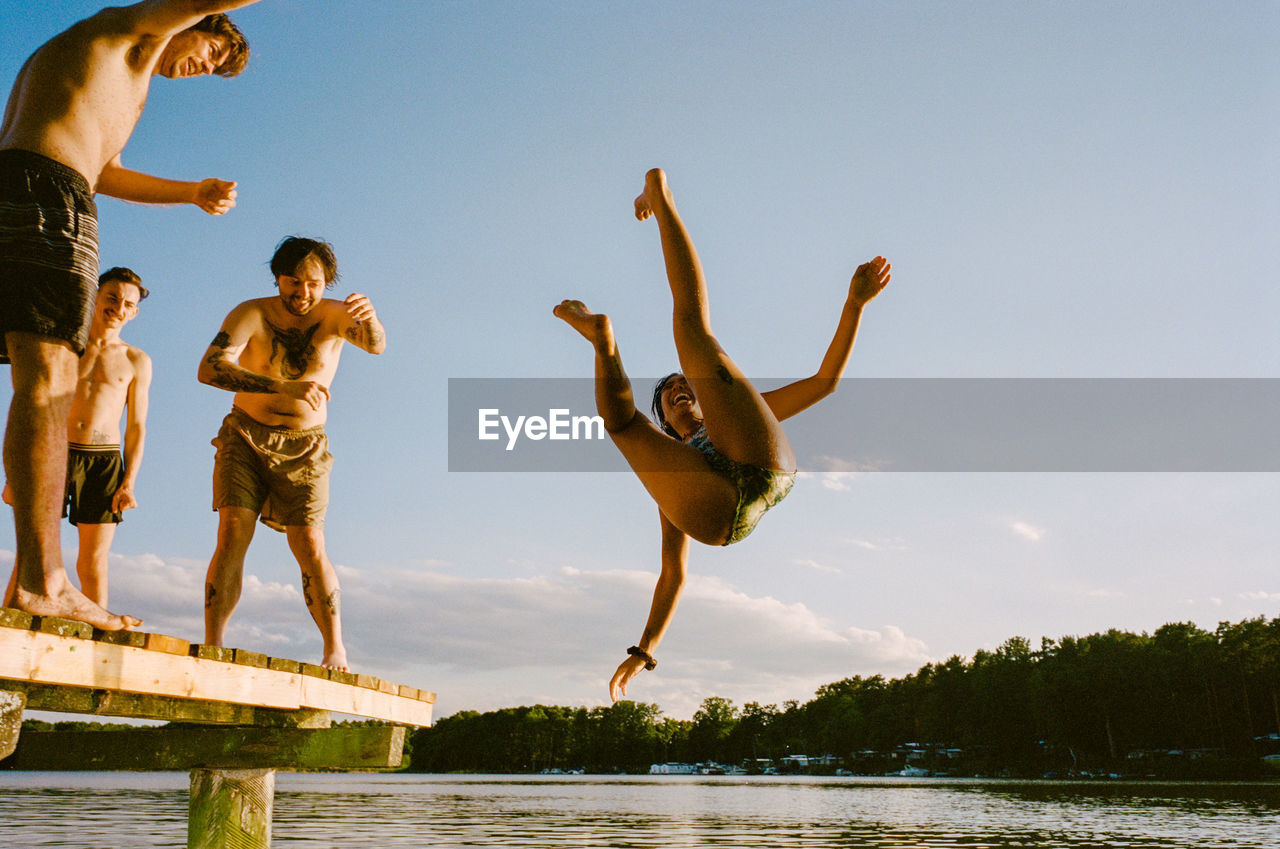 Low angle view of woman jumping in lake