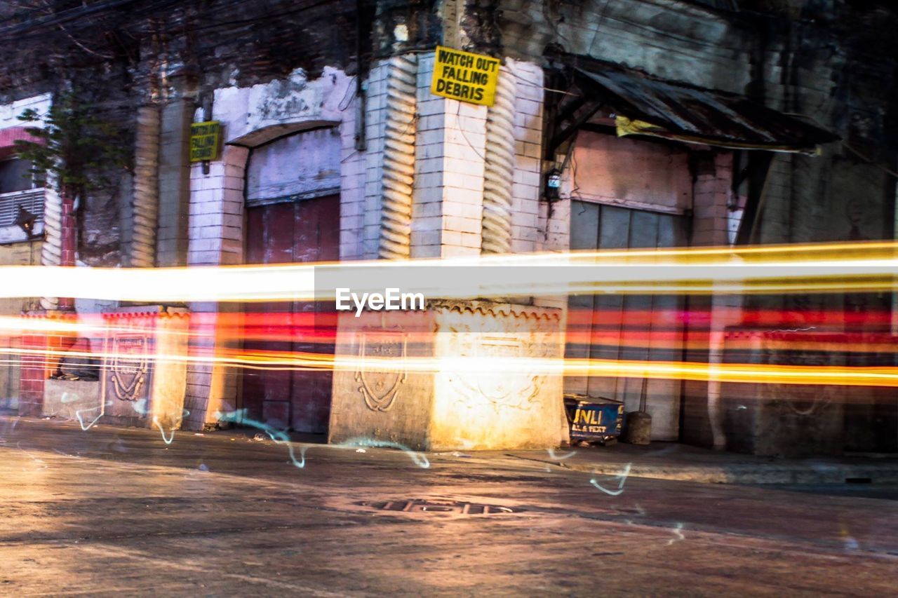 Light trails on road outside building