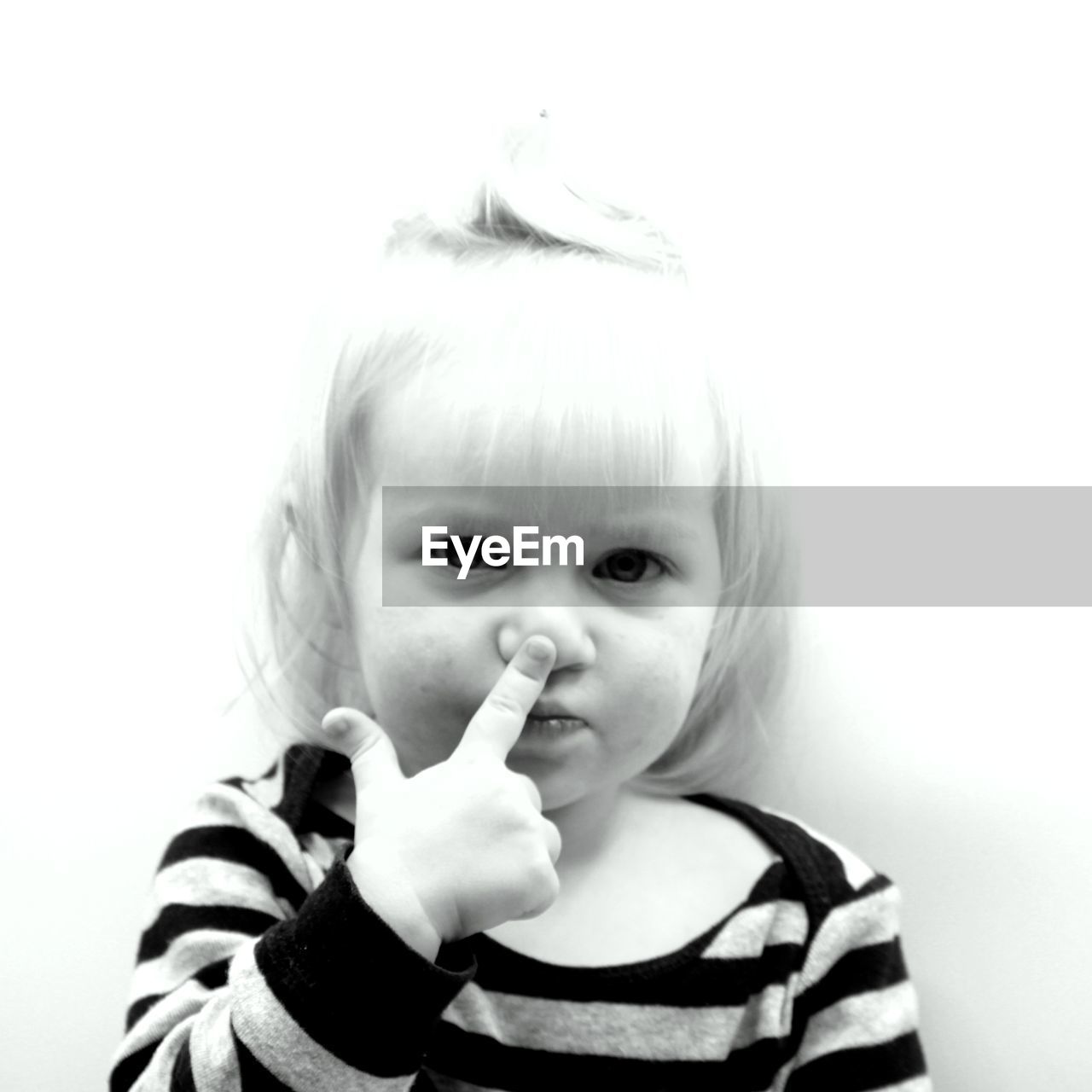 PORTRAIT OF A CUTE GIRL HOLDING GRAY BACKGROUND