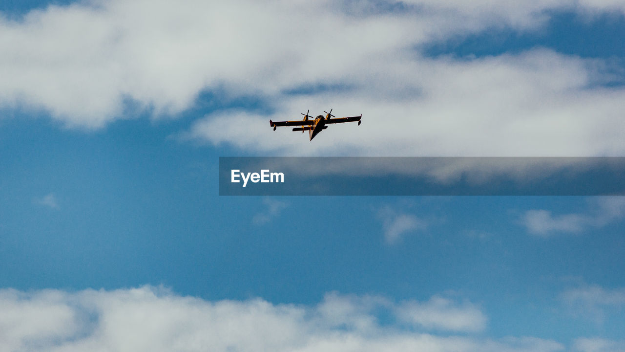 LOW ANGLE VIEW OF AIRPLANE IN SKY