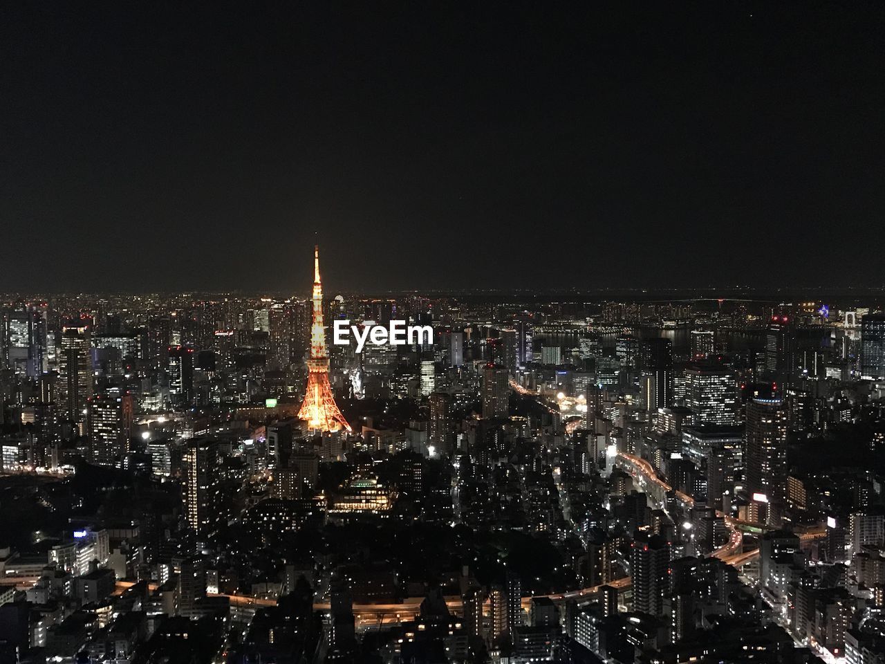 AERIAL VIEW OF ILLUMINATED CITY BUILDINGS AT NIGHT