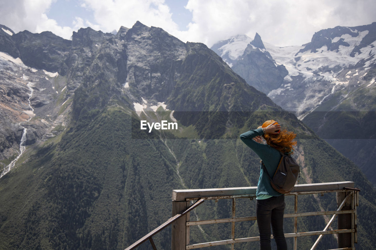 Woman looking at mountains while standing on observation point