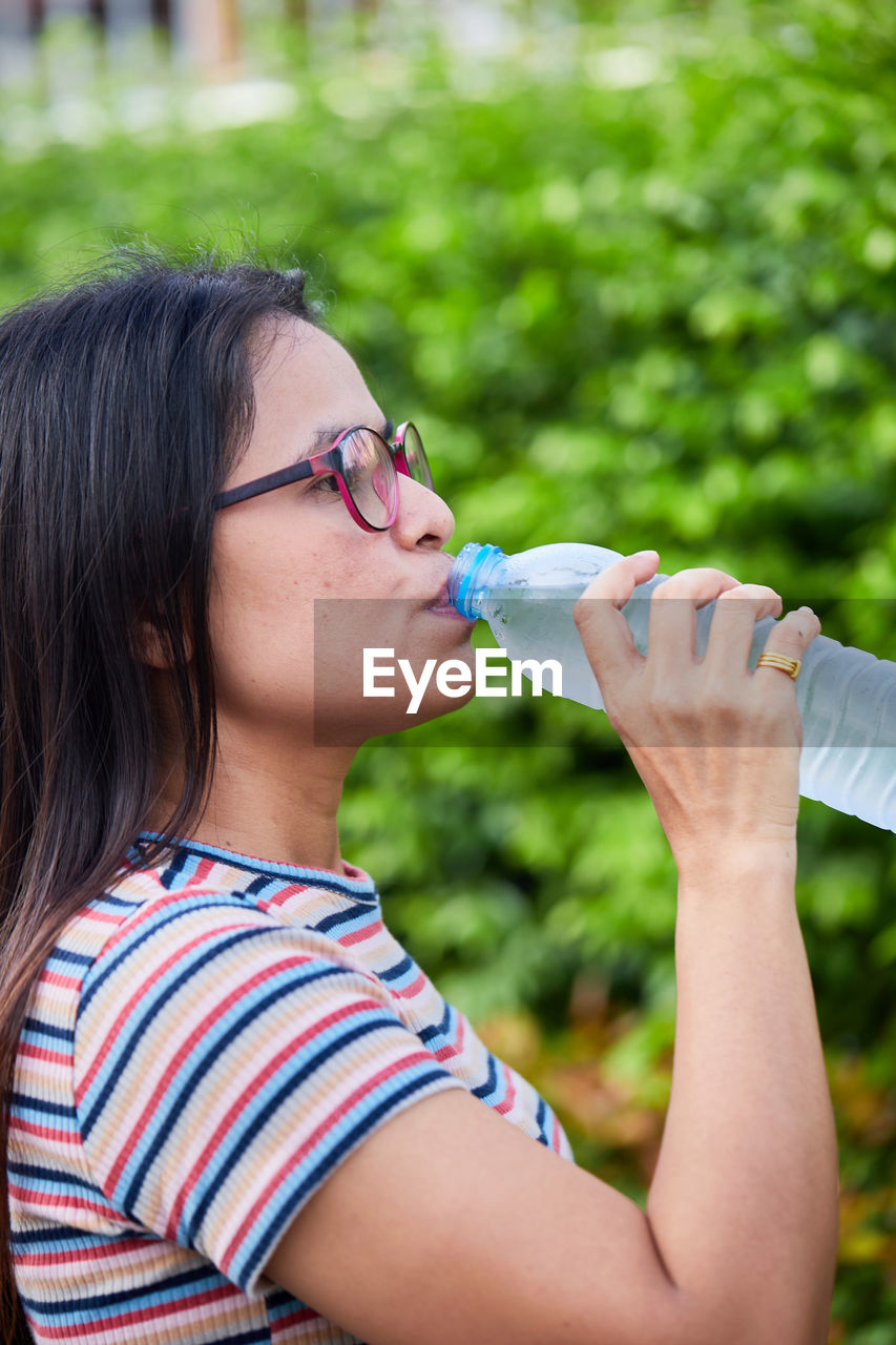 Woman drinking water from the bottle