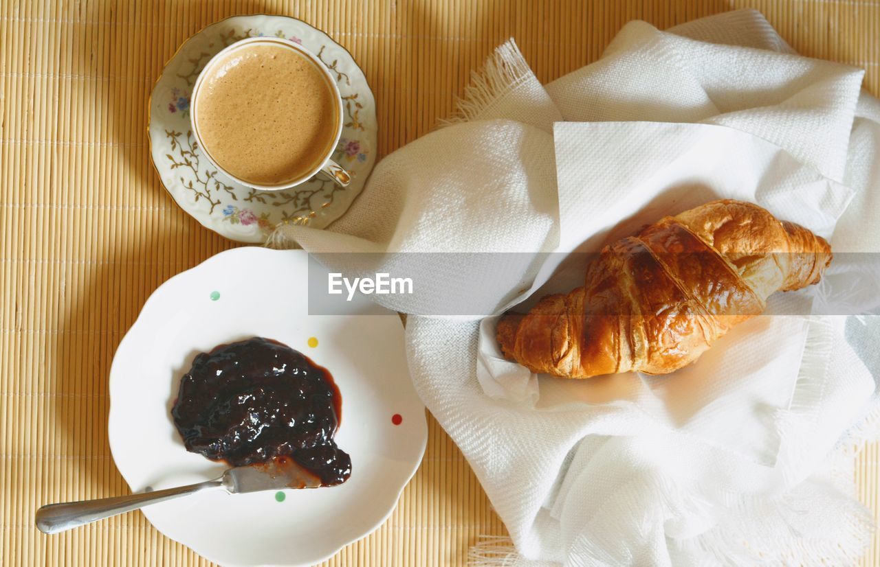 HIGH ANGLE VIEW OF BREAKFAST WITH COFFEE AND SERVED ON TABLE