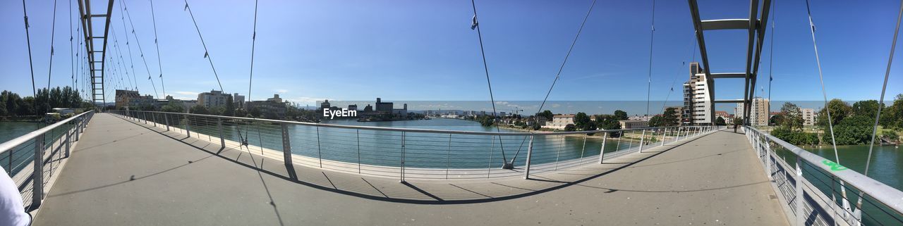 Panoramic view of river by city against blue sky