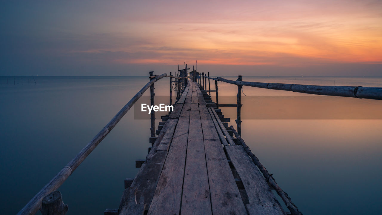 PIER ON SEA AGAINST SKY DURING SUNSET