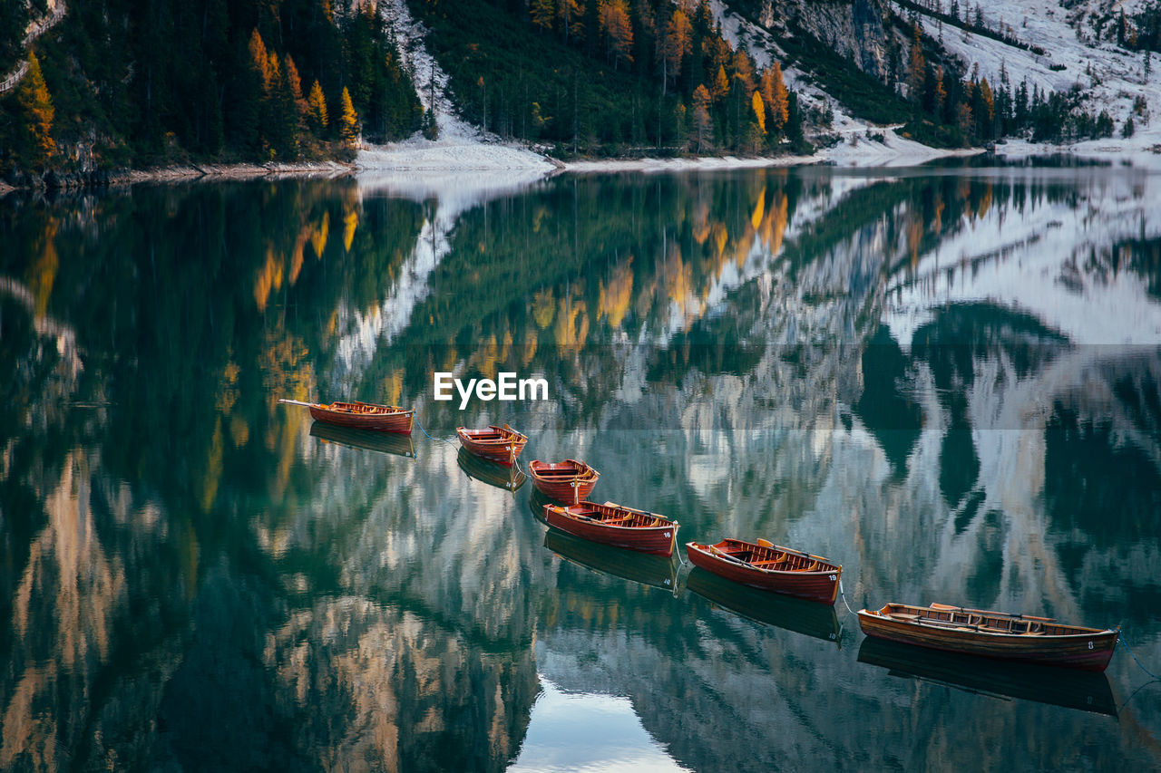 Boats in lake against mountains