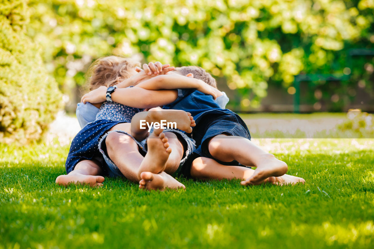 Rear view of father and son on grass