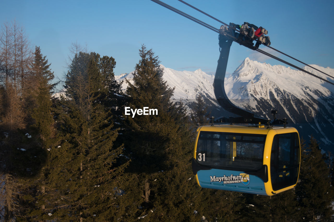 SKI LIFT OVER SNOWCAPPED MOUNTAINS