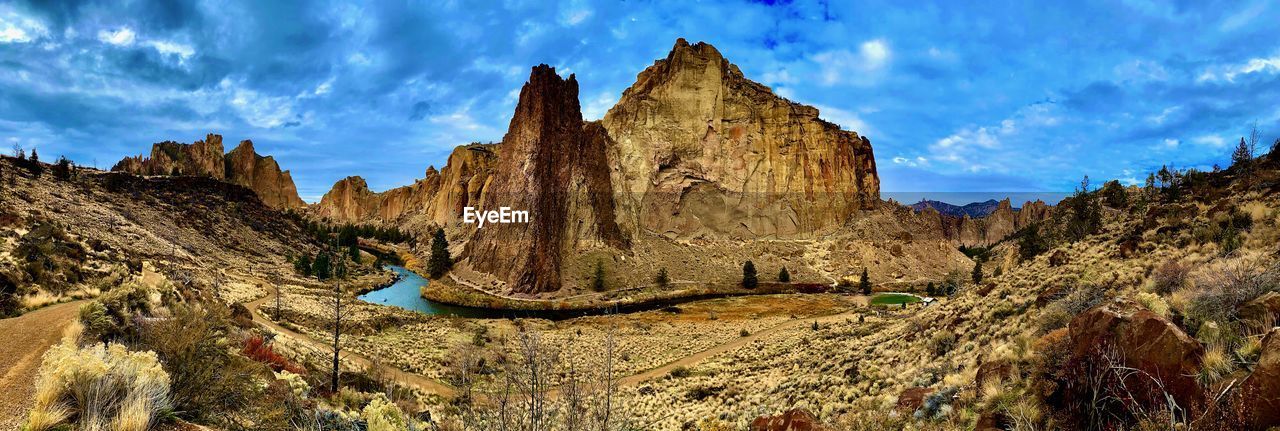 PANORAMIC VIEW OF ROCKS AND MOUNTAINS AGAINST SKY