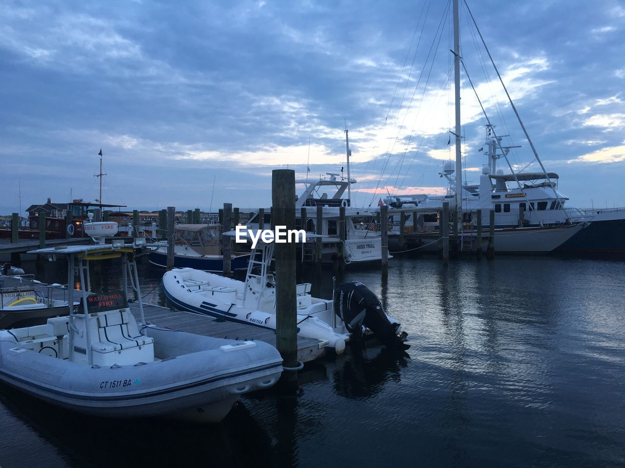 BOATS MOORED AT HARBOR BY SEA AGAINST SKY