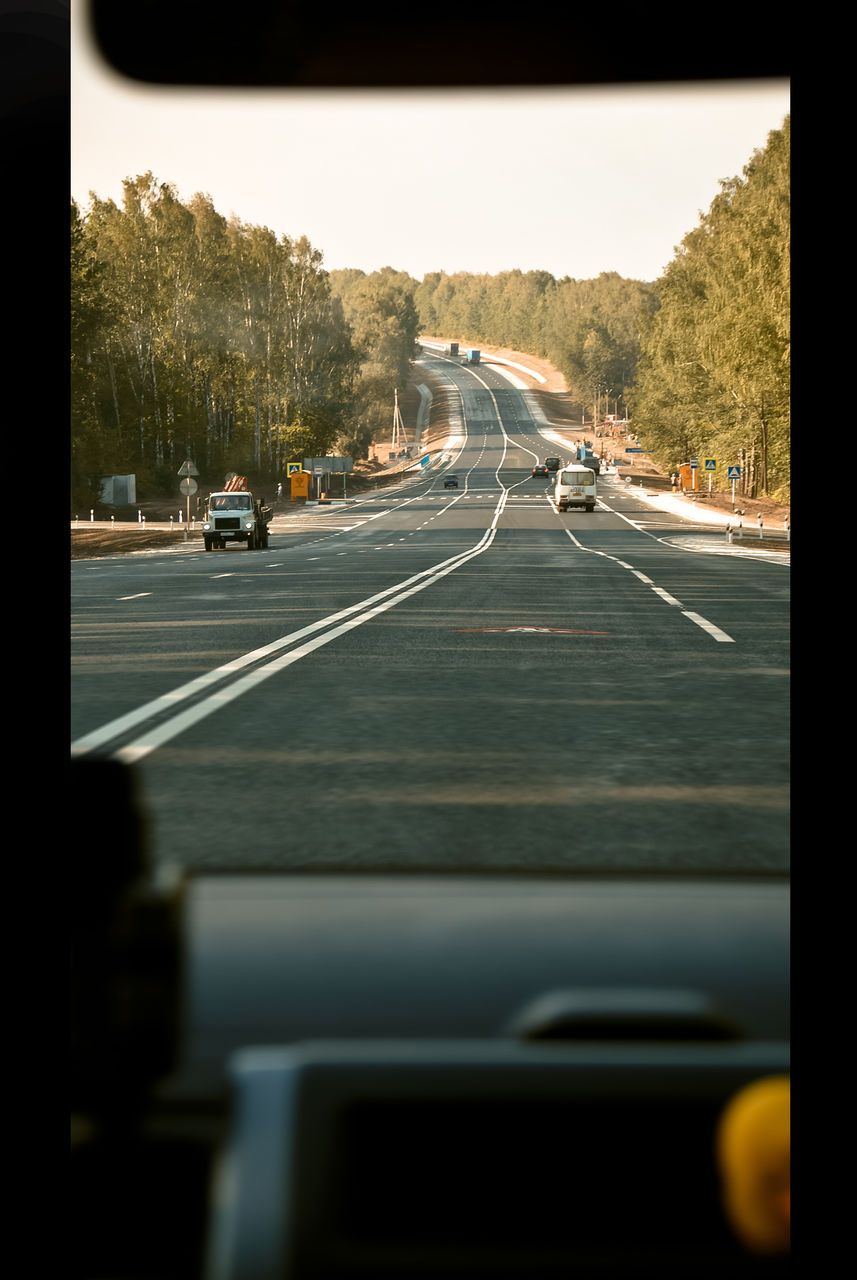 Cars on street seen through car windshield