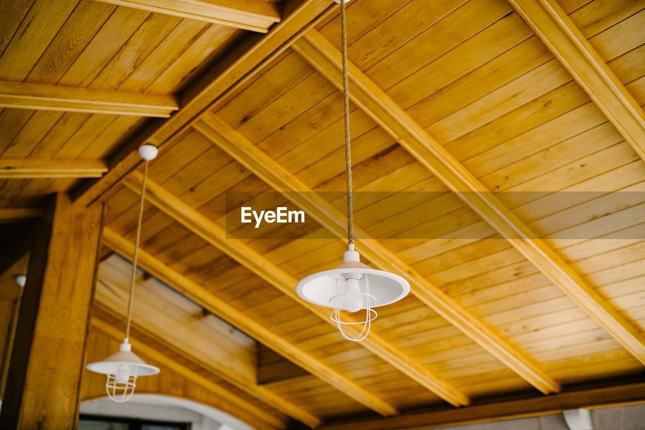 Low angle view of illuminated light hanging from ceiling