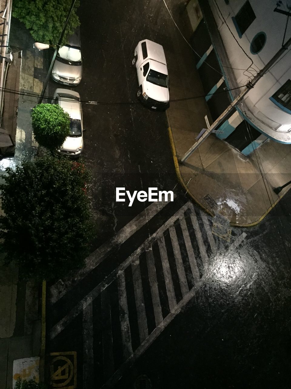 High angle view of wet city street at night during monsoon