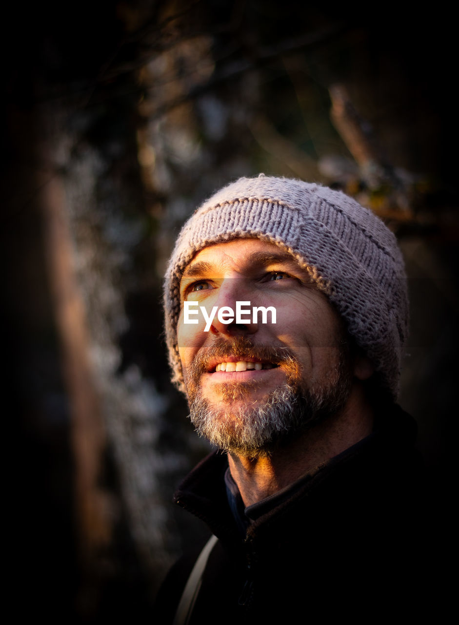 portrait of man standing against trees