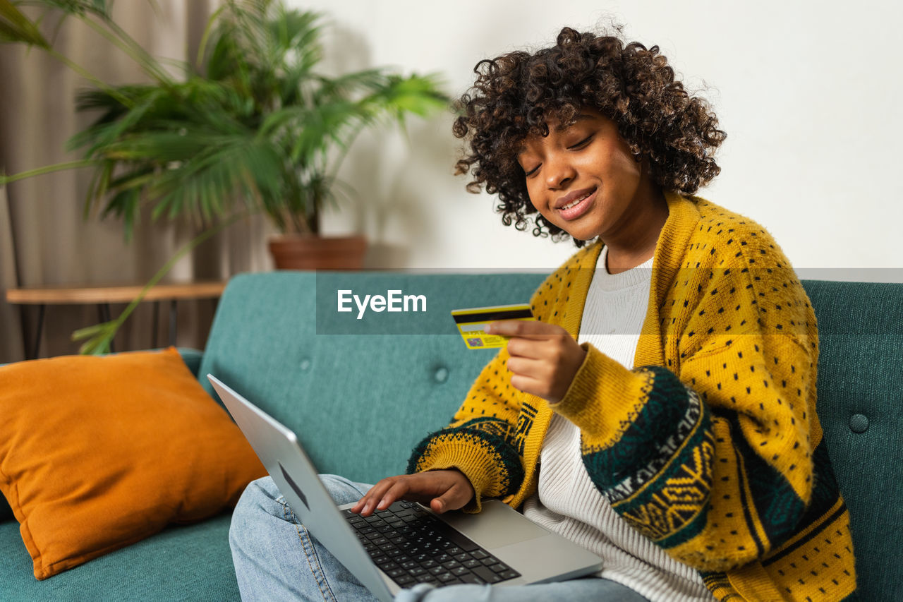 young woman using laptop while sitting at home