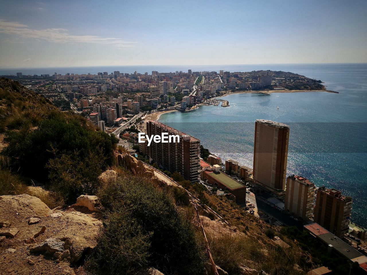 High angle view of buildings and sea against sky