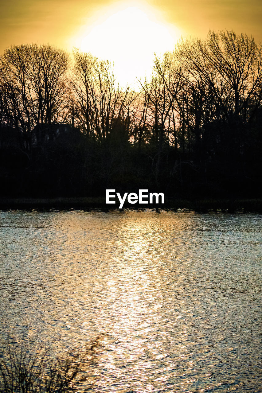 SCENIC VIEW OF LAKE AGAINST ORANGE SKY