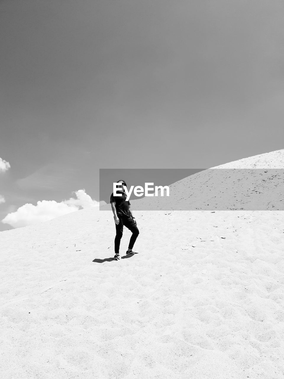 Full length of person on sand mountain against sky