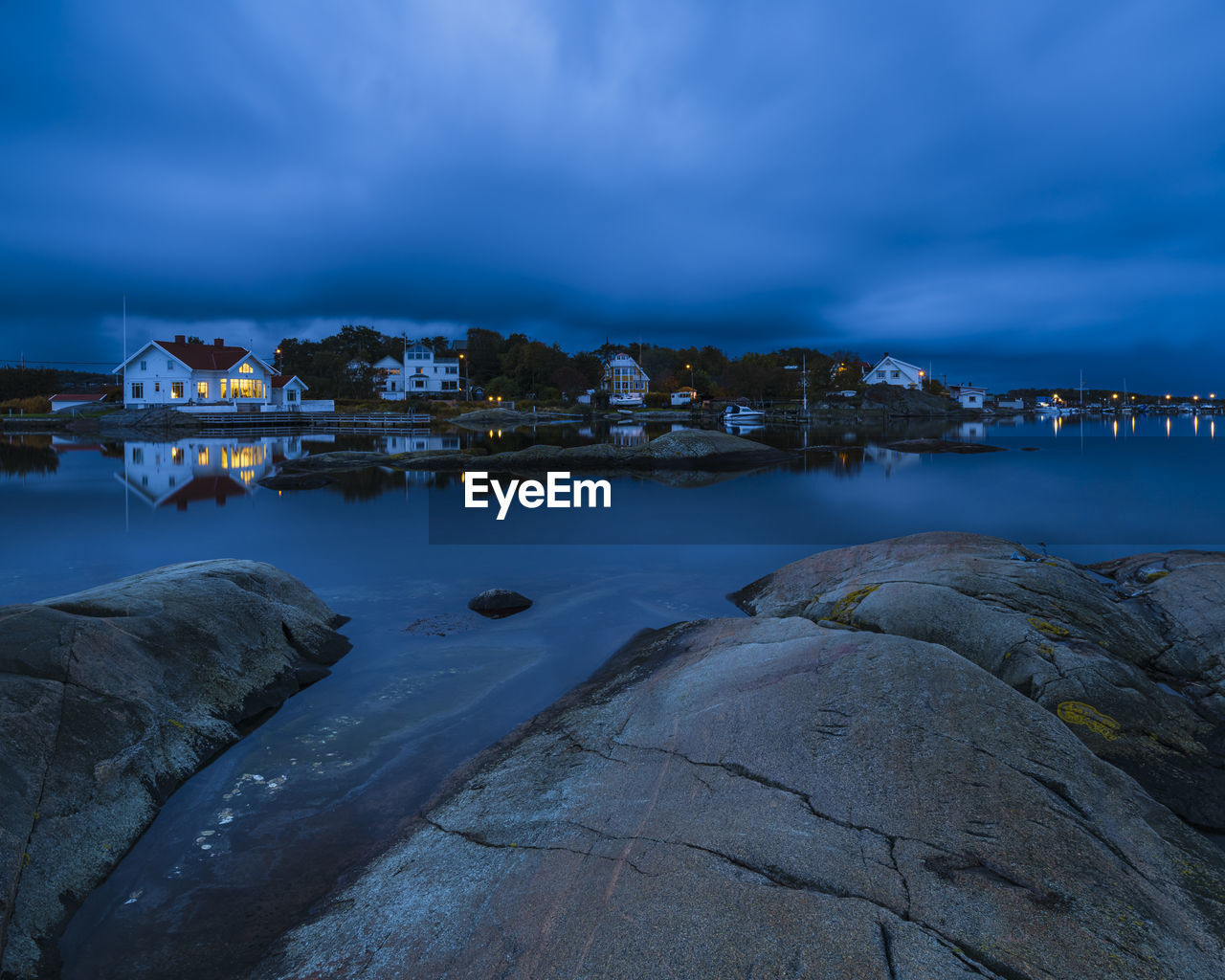 Houses on sea shore at dusk