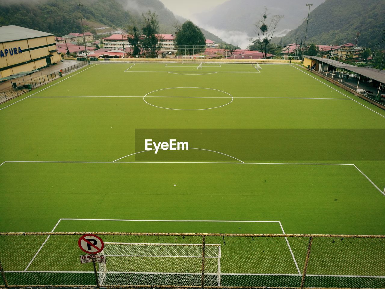 HIGH ANGLE VIEW OF SOCCER FIELD AGAINST GREEN WALL