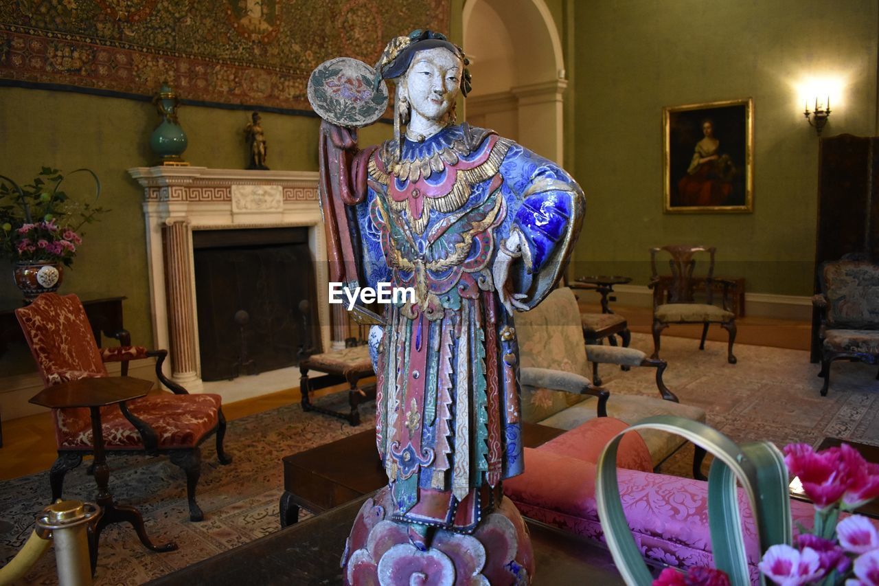 STATUE IN ILLUMINATED ROOM