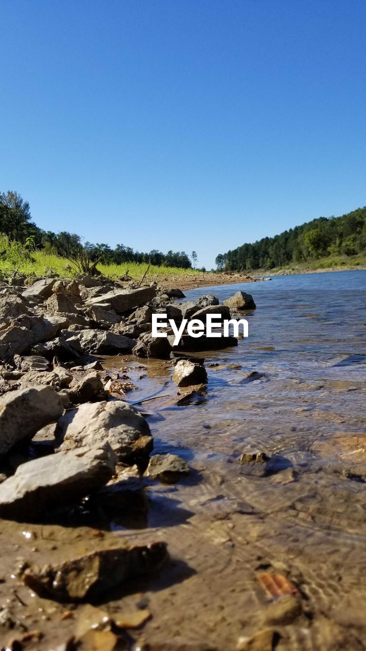 SURFACE LEVEL OF ROCKS AGAINST SKY