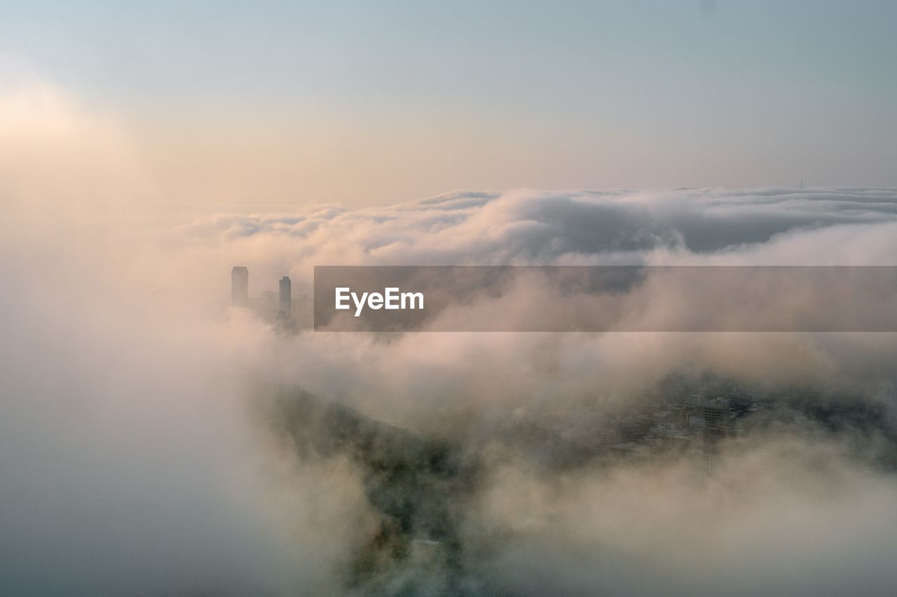 AERIAL VIEW OF CLOUDS OVER LANDSCAPE AGAINST SKY