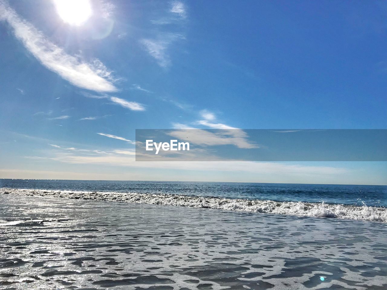 Scenic view of sea against blue sky