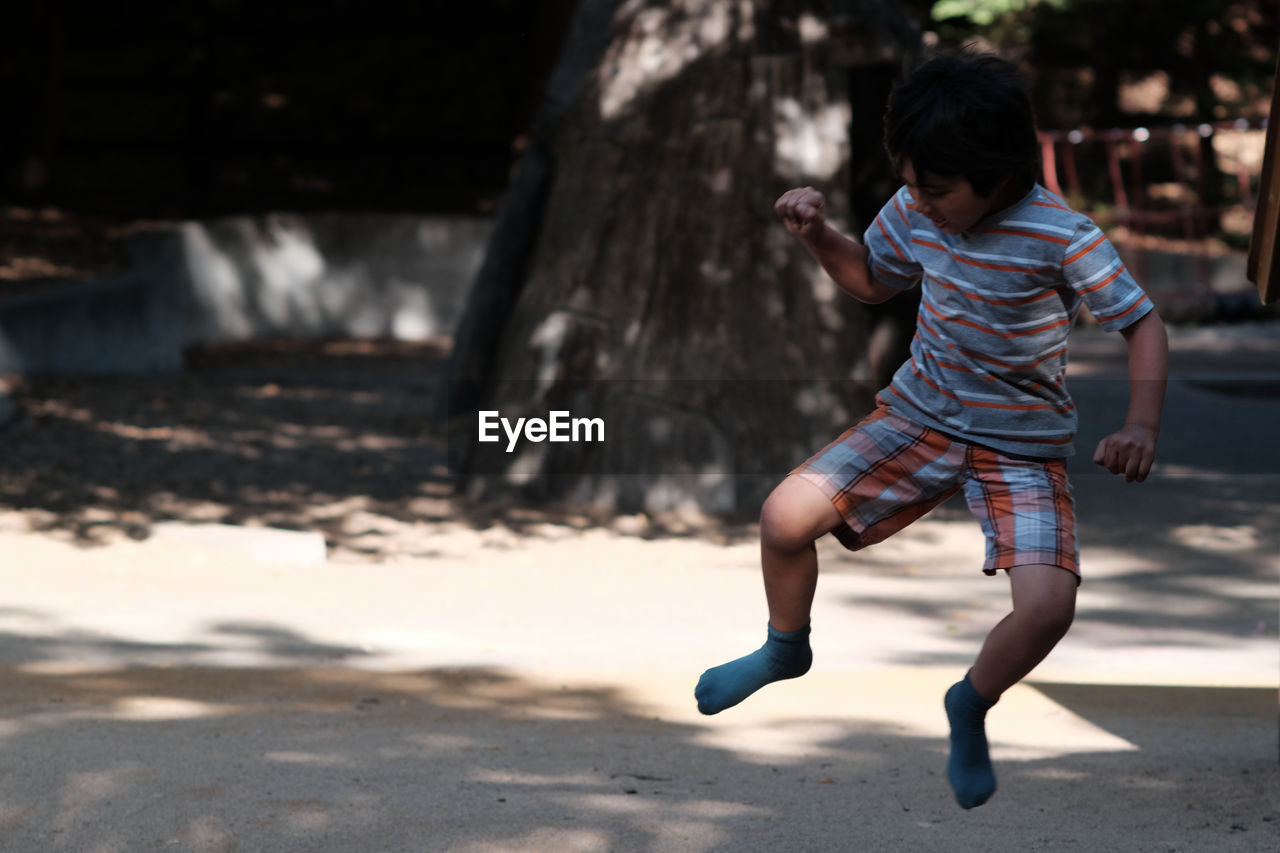 Full length of boy jumping at playground