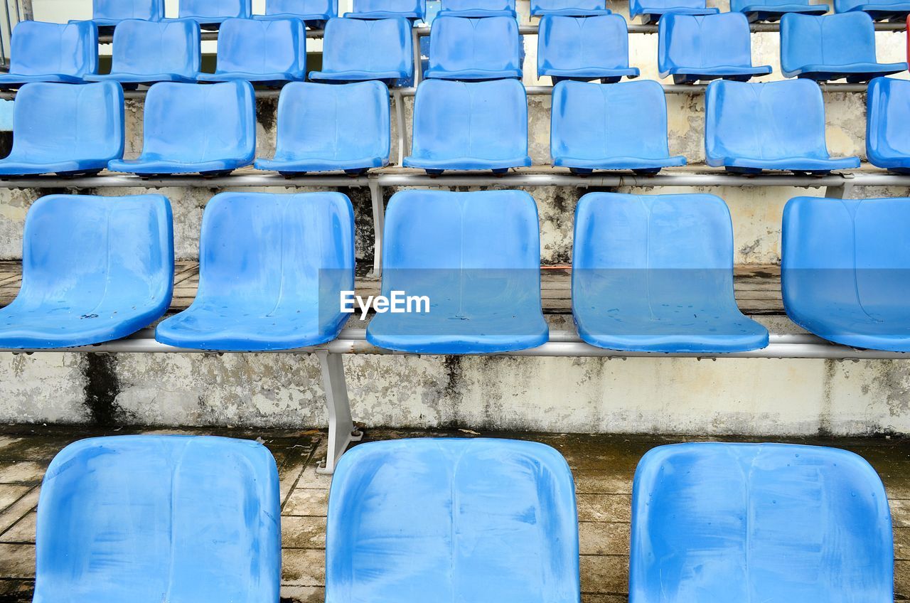 Full frame shot of empty blue seats in stadium