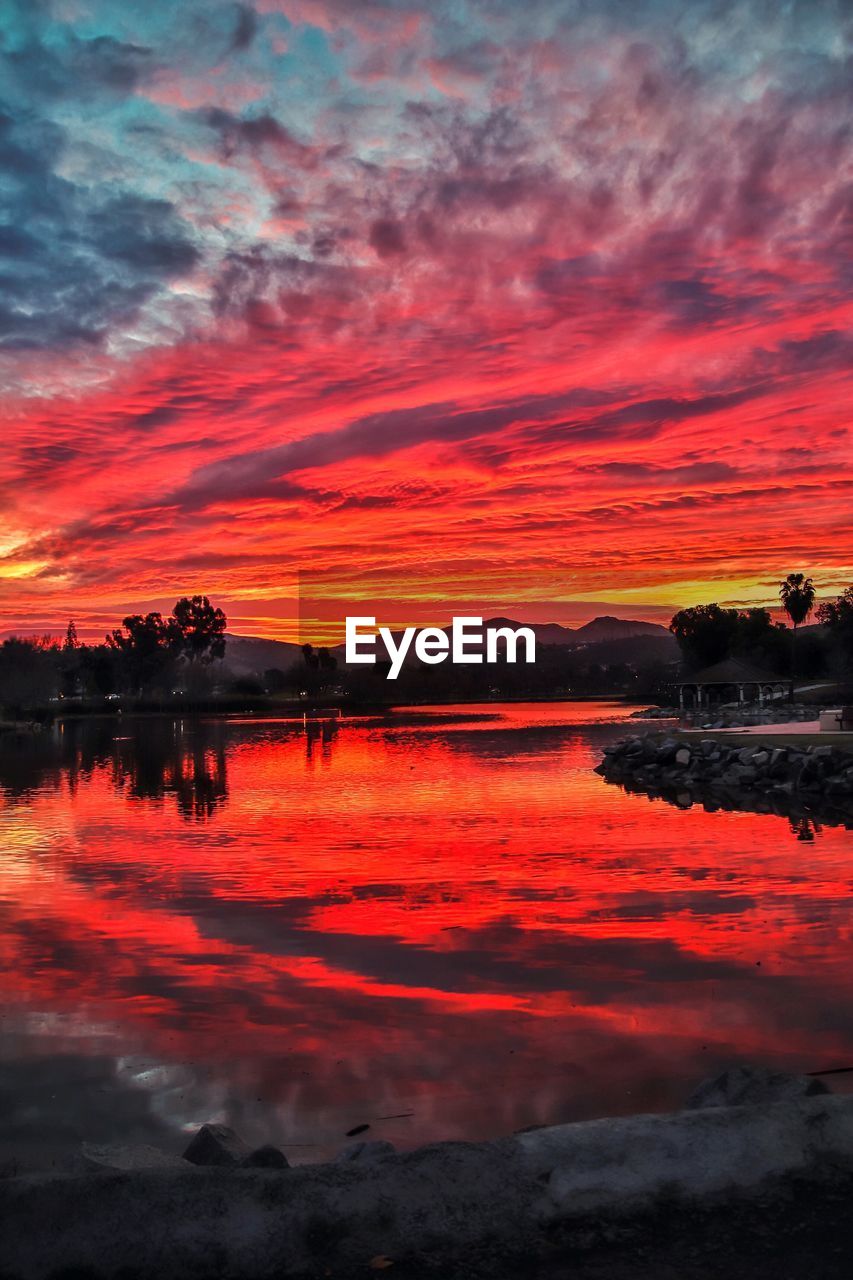 SCENIC VIEW OF LAKE AGAINST DRAMATIC SKY