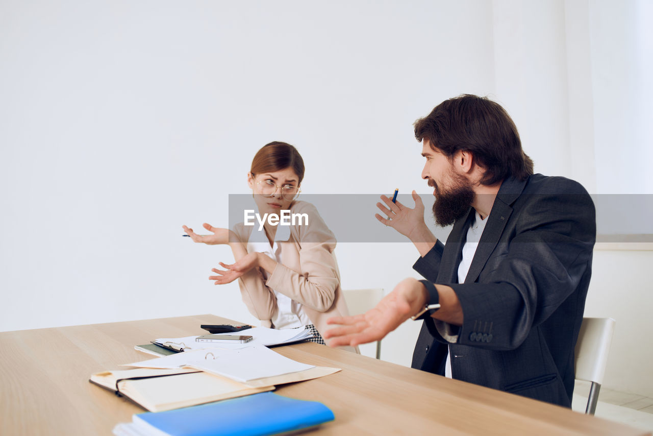 Business people discussing with papers on table