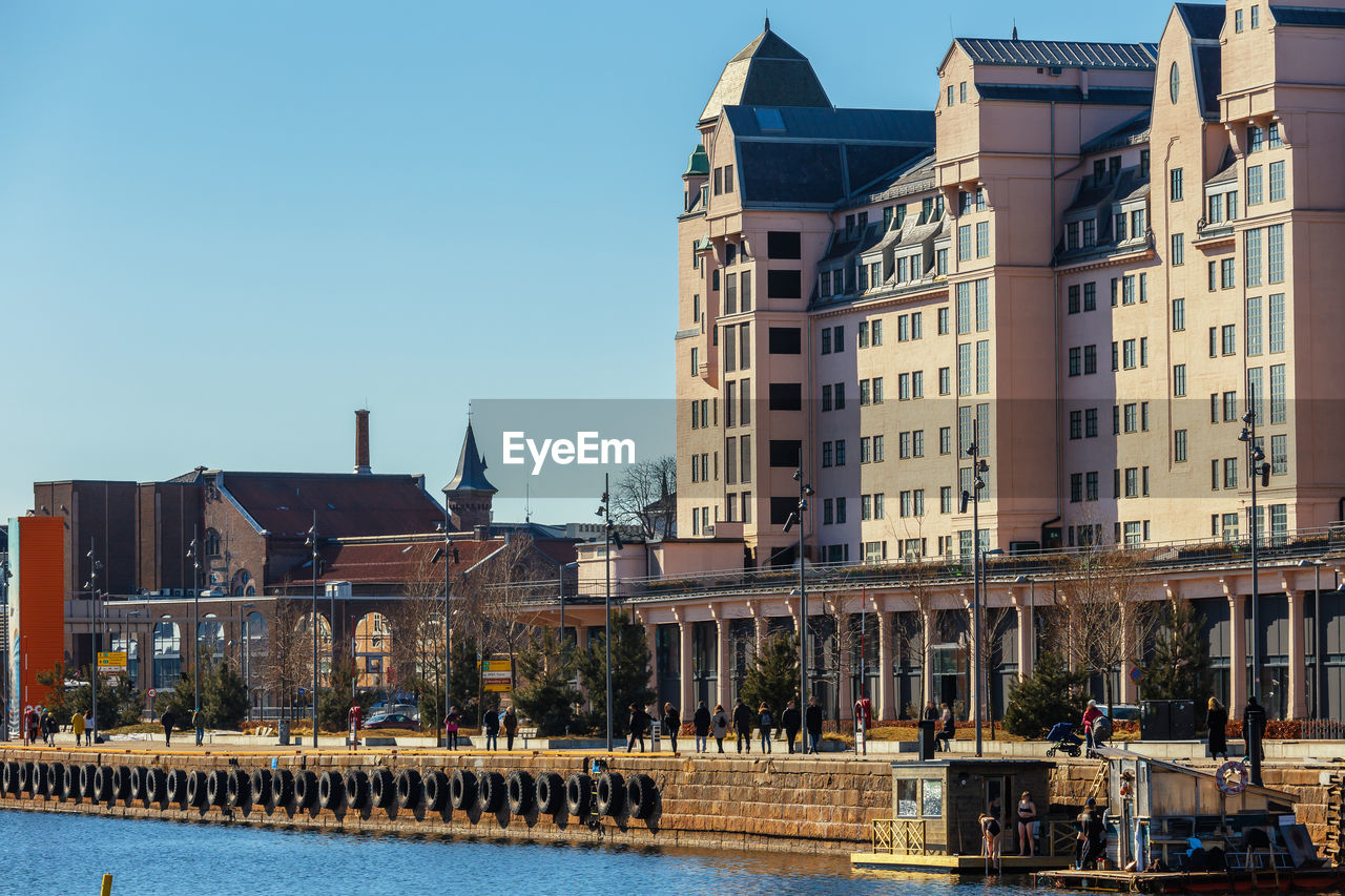 building exterior, built structure, architecture, building, sky, city, day, clear sky, nature, water, travel destinations, window, incidental people, residential district, outdoors, waterfront, tower, city life, canal, office building exterior, spire, skyscraper