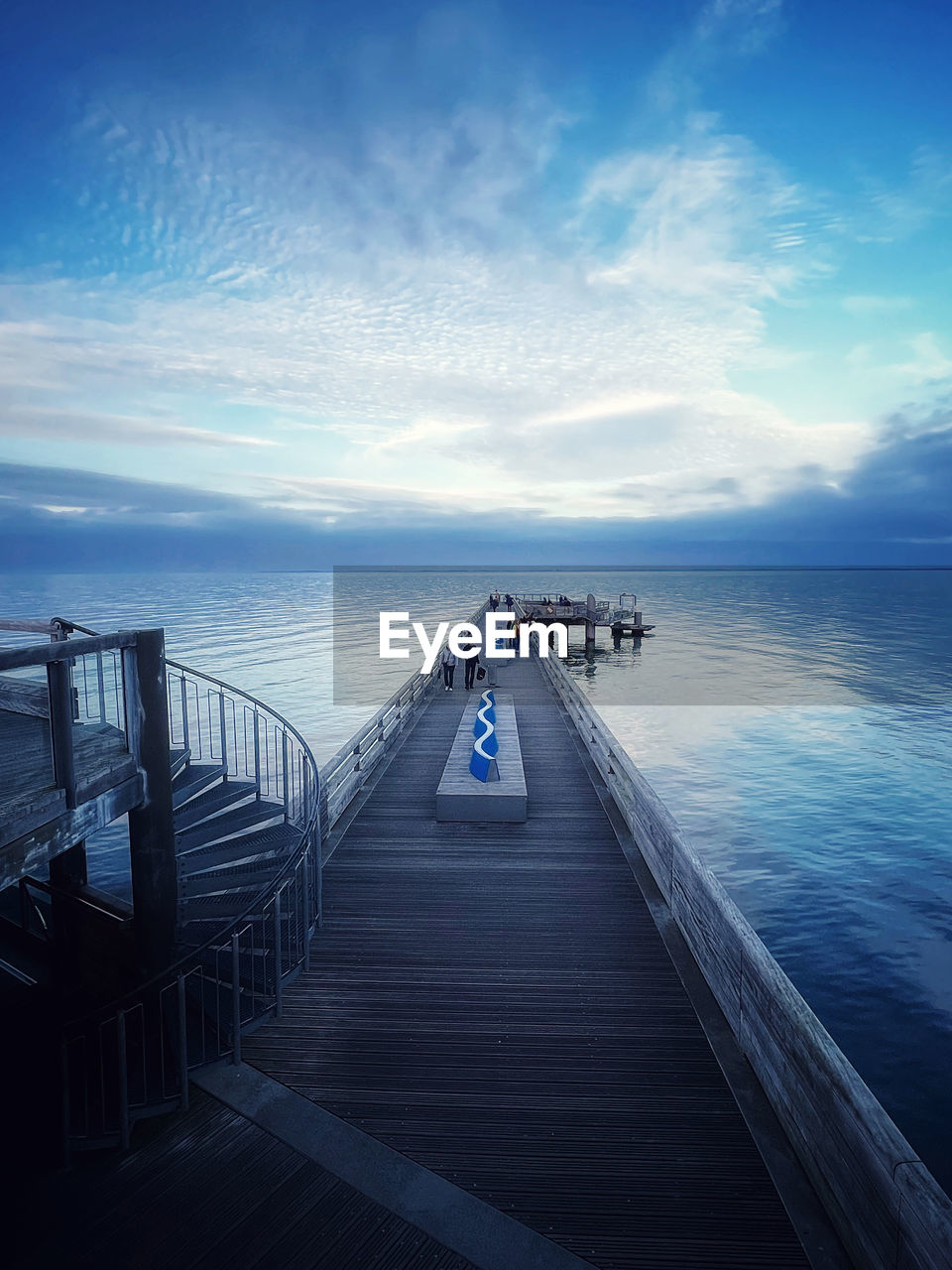 water, sky, horizon, sea, ocean, nature, reflection, cloud, blue, railing, transportation, pier, architecture, beauty in nature, scenics - nature, the way forward, beach, coast, horizon over water, tranquility, dusk, travel, land, travel destinations, sunlight, outdoors, holiday, jetty, vacation, tranquil scene, built structure, trip, wave, day, footpath, motion, tourism, staircase, nautical vessel, morning, lifestyles, adult