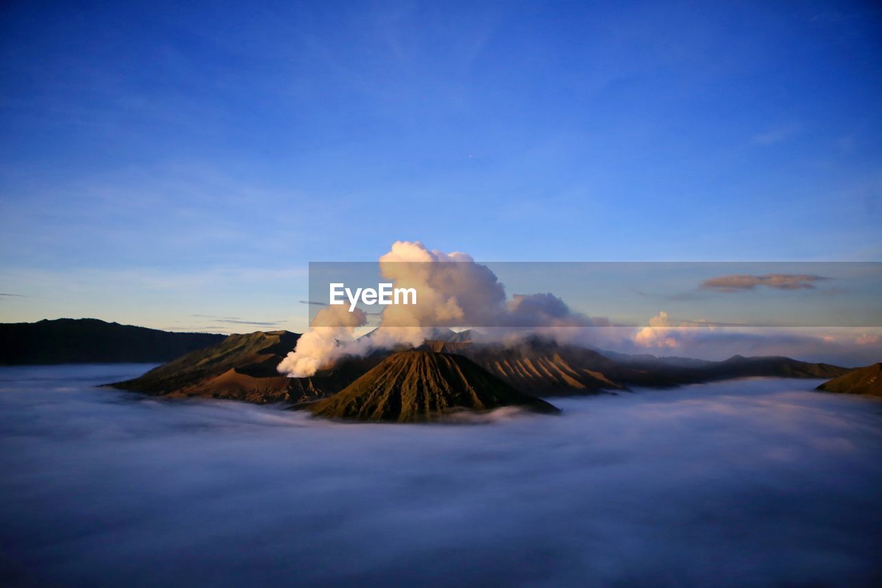 Scenic view of mountains against blue sky at sunset