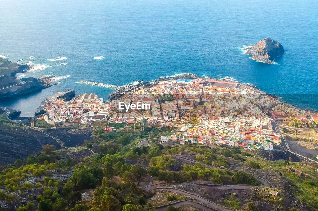 High angle view of townscape by sea