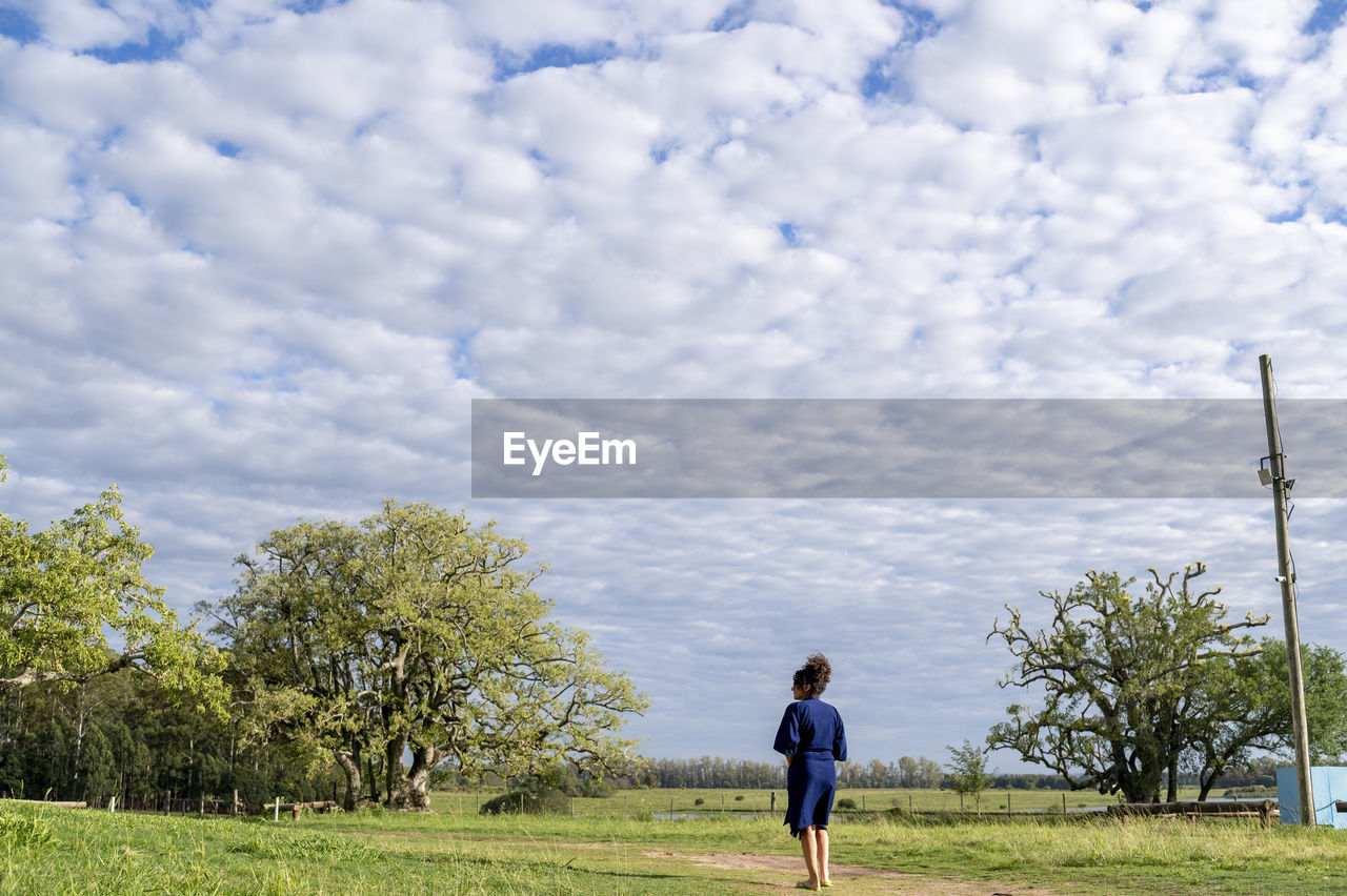 Woman walking outdoors in the field.